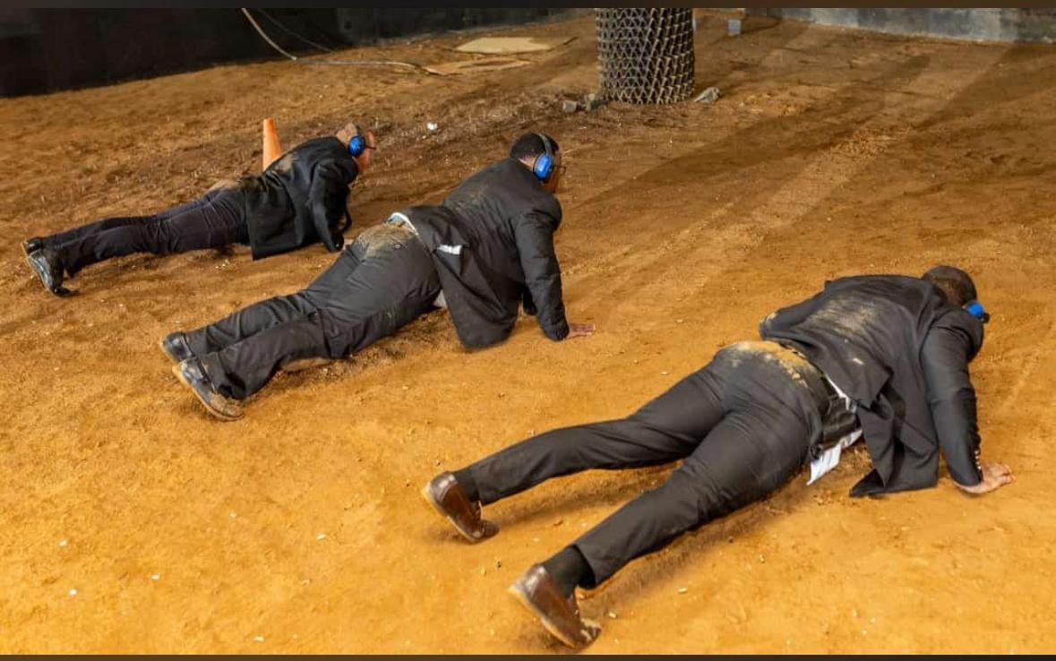KM VIP Protection officers in tactical low-crawl drill wearing hearing protection
